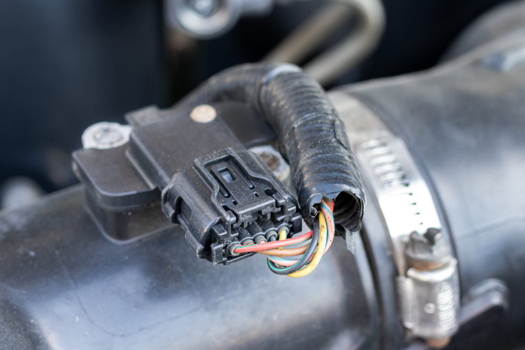 If you’re having problems with your car’s engine, it could be due to a bad air flow sensor. Learn about the symptoms of a bad air flow sensor, the causes, and what it costs to have it replaced.  What Is a Mass Air Flow Sensor?  A mass airflow sensor is an integral part of a vehicle’s engine. It determines the mass flow rate of the air entering fuel-injected internal combustion engines.   This measurement and information are essential for the engine’s control unit to monitor to ensure a balanced delivery of fuel mass into the engine. Air density changes when temperature and pressure change, so the airflow rate fluctuates often when the engine runs.   Most modern air flow sensors utilize a hot wire and a temperature gauge to monitor the temperature of the air around the wire. The more power the engine uses, the higher the temperature rises.  Mass Air Flow Sensor Location  The mass air flow sensor is between your car’s air filter and the intake manifold of the engine.  Mass Air Flow Sensor Problems  When problems arise with this piece of equipment, it can result in some troubling engine activity.   When you have an issue with your mass air flow sensor, the airflow readings it provides will not be accurate. You can tell they are inaccurate if the reading does not change when the car goes from idling to engine revolutions.   To tell when the mass air flow sensor needs attention, you’ll need to check the readings and know what a normal reading should look like.   Common symptoms of a bad mass air flow sensor include a lack of power, poor acceleration, check engine light, rough idling, no-start, stalling, and issues with your automatic transmission. We’ll cover them in-depth below. What Is a Normal Mass Air Flow Sensor Reading?  The expected mass air flow sensor reading will differ depending on the size of the engine. But the standard air flow reading should be 2 to 7 grams per second (g/s) when the engine is idling. The air flow reading should rise to 15 to 25 grams per second at 2500 revolutions per minute (rpm).  Symptoms of a Bad Mass Air Flow Sensor If you suspect a faulty air flow sensor, there are a few symptoms to watch out for. Bear in mind these symptoms can also indicate other engine problems, but they’re characteristic of a mass air flow sensor, and you can rule out the sensor by taking a reading.   Below are common symptoms to keep an eye out for if you suspect there’s something wrong with your mass air flow sensor.  Lack of Power or Poor Acceleration If the car struggles to accelerate and there feels like a lack of power, it could be because the air flow sensor is faulty or dirty. When this happens, the engine can’t properly accelerate because it doesn't know the amount of air moving through it.  Check Engine Light A classic symptom of car problems is if your “check engine” light or “service engine soon” light comes on. It could be indicating your mass air flow sensor needs to be replaced or cleaned.   If that light comes on, always be sure to get it checked out ASAP to avoid further damages to your vehicle.  Automatic Transmission Problems If your automatic car struggles to switch gears, it may be due to the air flow sensor improperly reading the amount of air moving through the engine. The sensor plays an integral role in gear shifting as more air flowing indicates to the engine that you need to go up a gear.  Rough Idling If the engine idling is not a consistent and steady hum or rumbling, the air flow sensor may be on the fritz. A rough and inconsistent idling where the engine sputters and seems to struggle can mean the air flow sensor readings change too quickly, affecting how the engine runs.  No-Start If you can’t get your car to turn on, the mass air flow sensor may be to blame. If the sensor reads there is too much air flow, it can prevent the engine from starting altogether.  Stalling If your car is frequently stalling and you can’t determine any other causes, it could be because the readings on the air sensor are fluctuating too much, causing the engine to stall.  Mass Air Flow Sensor Failure Causes  There are a few different causes of a bad air flow sensor. You can avoid some of these, but others are just a normal part of an engine’s life. Below are the five common causes of mass air flow sensor failure.  Damage If the air flow sensor is damaged, whether in an accident or due to long-term wear and tear, it will need to be replaced. Air flow sensors are delicate, and repairing one is practically impossible, so it needs replacing if it has taken any damage.  Contamination A contaminated mass air flow sensor means your mass air flow sensor is dirty. The contamination can be debris, dust, grease, and other substances that travel through the engine often and get trapped in the sensor.   Mass air flow sensors can be cleaned very carefully, but often, this is only a temporary solution, and it's better to replace them.  Improperly Installed Air Filter An air flow sensor delivering strange and false readings may have been installed improperly. A mechanic will easily be able to diagnose this problem, and if there’s no damage to the sensor, they can probably reinstall it for a small labor cost.  Collapsed Air Filter Every mass air flow sensor has a filter which helps keep the sensor and the engine cleaner for longer.   If the air filter collapses or becomes dislodged, the sensor and engine will get much dirtier and become contaminated, requiring you to either replace the filter or replace the sensor altogether.   Replacing the filter can be difficult and result in damage to the sensor itself, so a complete replacement is often the best solution.  Over-Soaked Air Filter Some air flow sensors have washable filters. These washable filters are convenient because you can keep the sensor in good condition for longer and avoid contamination.   However, if the air filter is still wet when you replace it in the engine, then air cannot properly flow through the sensor. Therefore, the sensor cannot accurately read the amount of air moving through it, causing your engine to misbehave and sputter.  How to Reset Mass Air Flow Sensor  All you need to do to reset the air flow sensor is unplug the car’s battery for ten minutes or more, then plug it back in! It’s super simple, and this could fix your air flow sensor if it is just a minor problem with the reading mechanism.  Can You Drive With a Bad Mass Air Flow Sensor?  While the engine will behave strangely, with inconsistent fuel being delivered to the combustion chamber, you can technically still drive. But driving with a bad air flow sensor typically leads to more engine problems.   If you don’t take care of the air flow sensor issues, other parts of your engine may fall into disrepair, costing you more money in the long run.  Mass Air Flow Sensor Price  A mass air flow sensor usually costs between $100 and $150. But some can cost up to $400, depending on the make and model of the car.  Mass Air Flow Sensor Replacement Cost  A damaged or contaminated air flow sensor may need to be replaced. Luckily, it’s not a super costly or complicated task. But most people will need to take their vehicle to a mechanic to determine the severity of the damage or contamination.   If it is dirty, your mechanic may be able to clean it, so it works again. However, most of the time, the sensor needs to be replaced, and this is a very delicate procedure, although simple.   The necessary replacement parts and labor can cost anywhere between $100 and $450, depending on the car's make and model. The parts are the most expensive part, while the labor for this usually only costs $25 to $50.   The most important aspect of replacing the air flow sensor if you try to do it yourself is to have the air filter installed and handle all parts very gently.